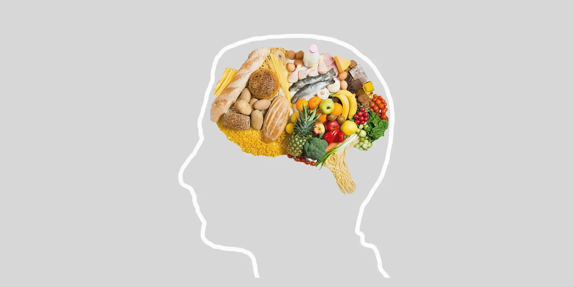 Outline of a human head with a brain-shaped arrangement of healthy foods, including fruit, vegetables, bread, fish and dairy products, illustrating the connection between nutrition and brain health.
